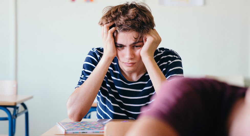 A boy sits on the depression students 