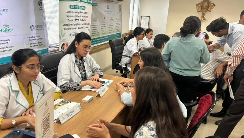 Medical professionals consulting patients at healthcare event.