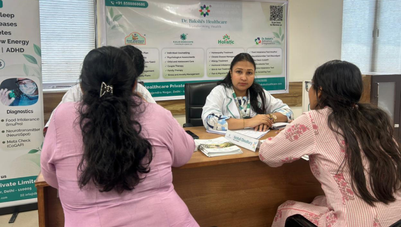 Nutritionist consulting patients at desk.