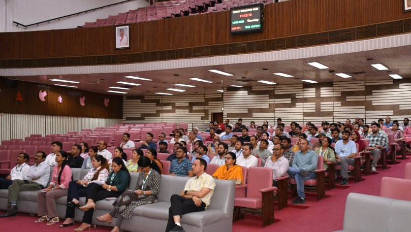 Audience seated in auditorium hall.