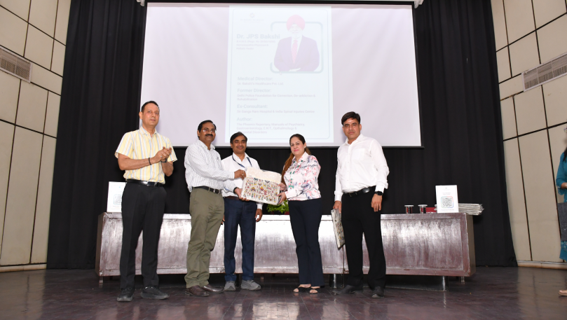Gift exchange on stage at CSIR wellness event.